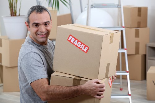 Loading household furniture into a moving truck in North London