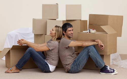 Team handling furniture removal in a flat with narrow stairs