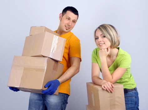 Removal team carrying boxes and furniture near a Finsbury Park property