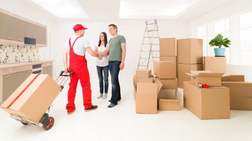 Local movers handling furniture on a Finsbury Park street