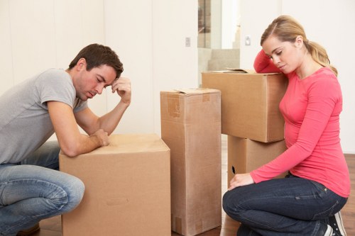 Professional movers navigating stairs and narrow access during a North London house removal