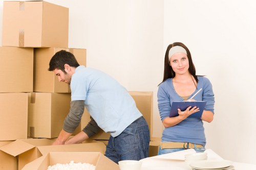 Professional office movers handling desks and equipment