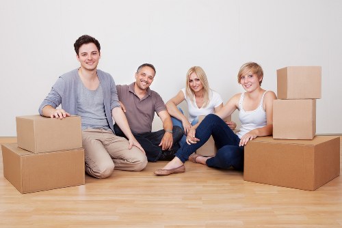 Movers transporting commercial equipment through a Finsbury Park property